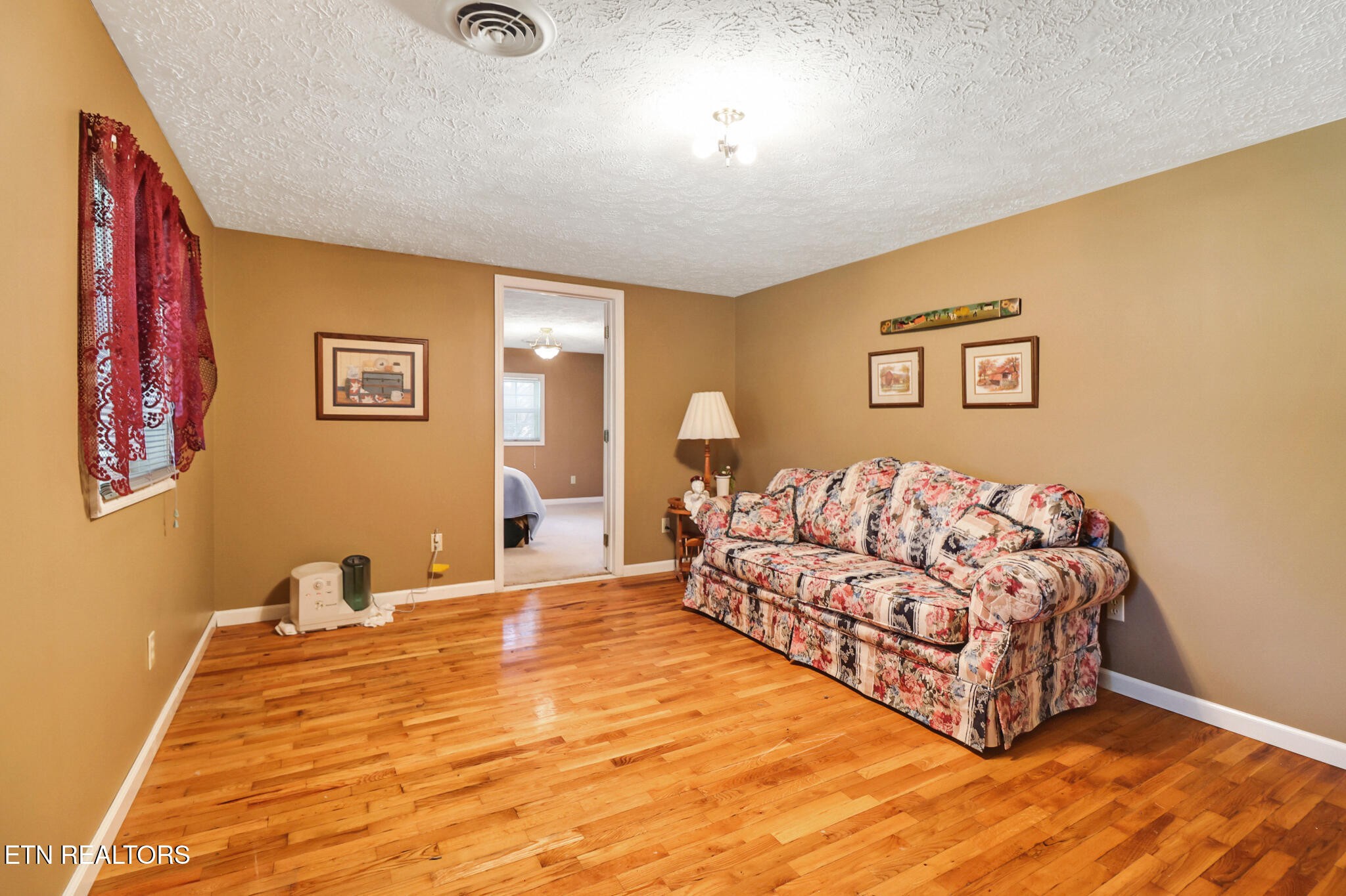 1729 Roslin Road Jamestown, TN 38556 - Photo 10 of 49 a spacious bedroom with a bed and a couch