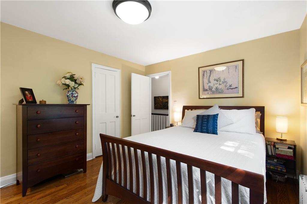 454 Sulgrave Road Pittsburgh, PA 15211 - Photo 23 of 50 a bedroom with a bed and wooden floor
