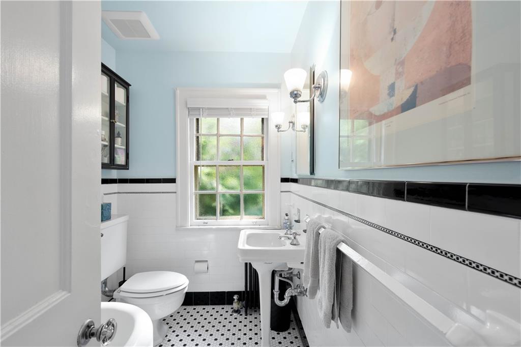 454 Sulgrave Road Pittsburgh, PA 15211 - Photo 24 of 50 a bathroom with a sink a toilet and a mirror