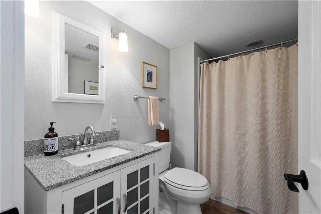 454 Sulgrave Road Pittsburgh, PA 15211 - Photo 30 of 50 a bathroom with a granite countertop sink and a mirror