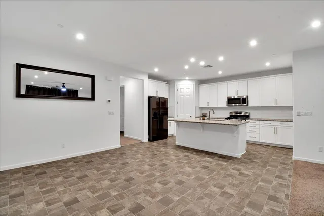 a living room with furniture and kitchen view