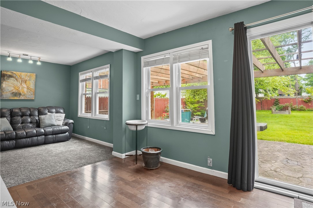 2122 Campus Road Cleveland, OH 44121 - Photo 16 of 39 Living room featuring a wealth of natural light, track lighting, and hardwood / wood-style floors