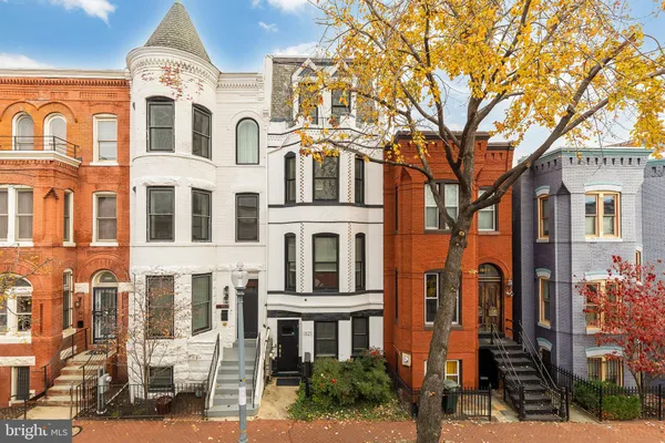 a front view of a residential apartment building with a yard