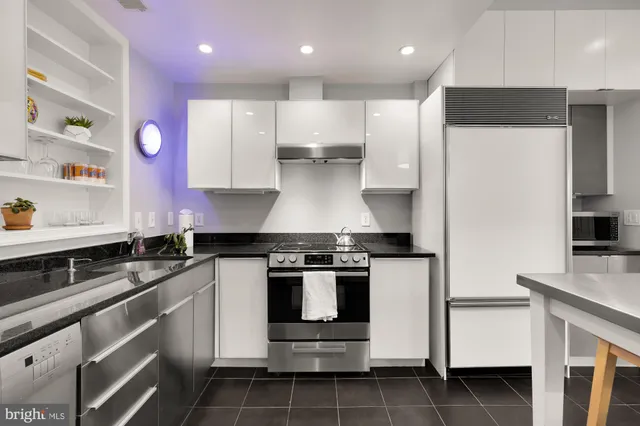a kitchen with a stove and white cabinets