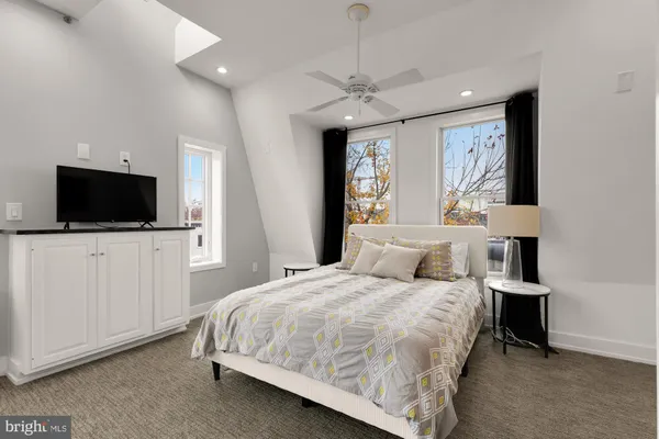 a bedroom with a large bed and a flat screen tv