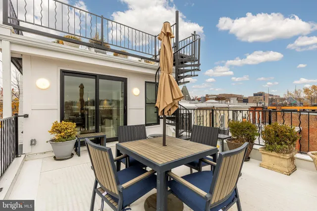 a view of a roof deck with furniture
