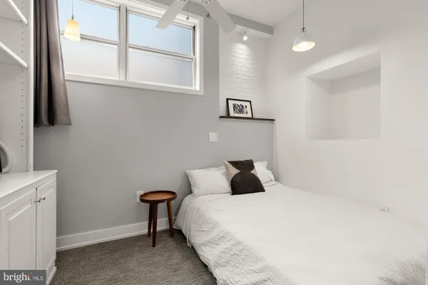 a bedroom with a bed and a window