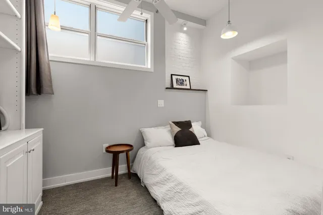 a bedroom with a bed and a window