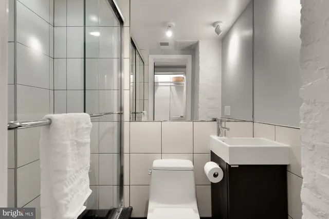a bathroom with a sink toilet and shower