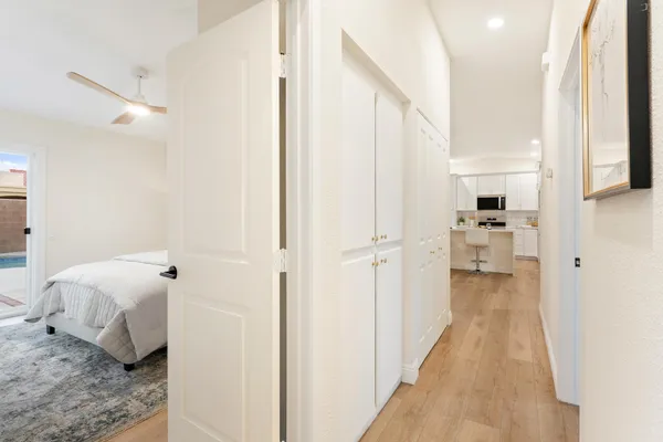 a spacious bedroom with a bed and a mirror