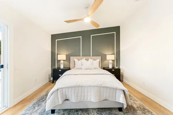 a bedroom with a bed and a mirror