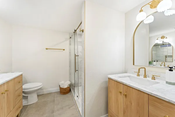 a bathroom with a toilet sink and mirror