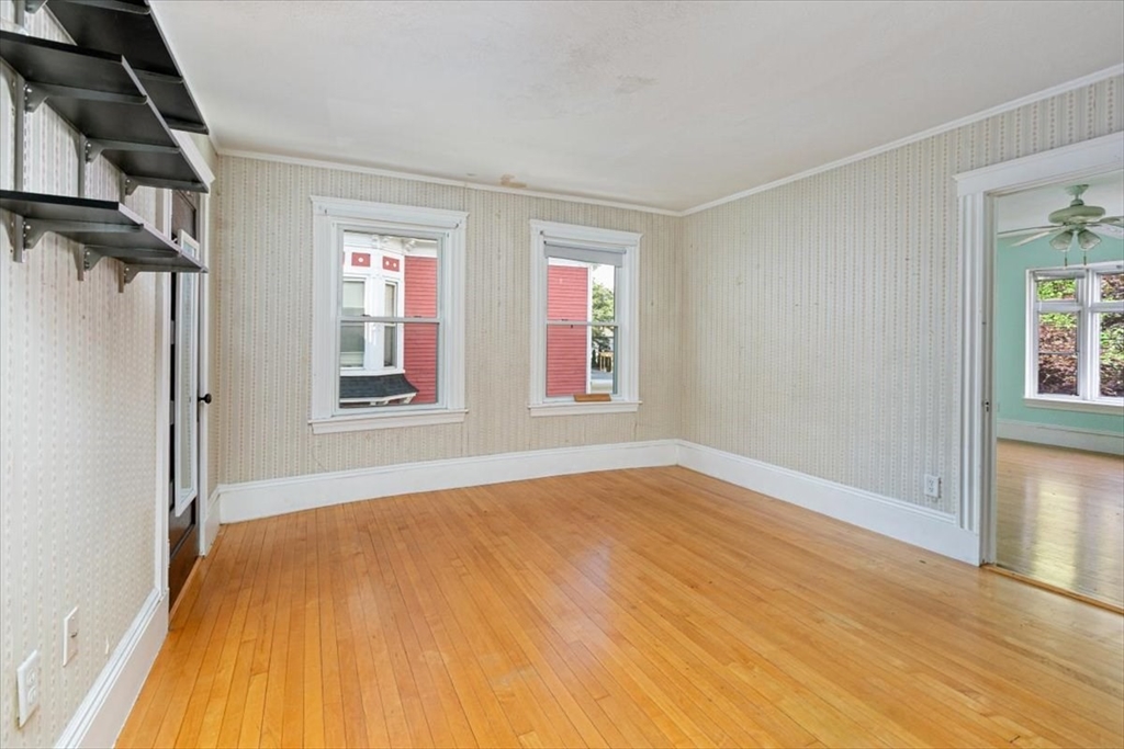 98 Webster Street Haverhill, MA 01830 - Photo 27 of 42 a view of empty room with wooden floor and fan