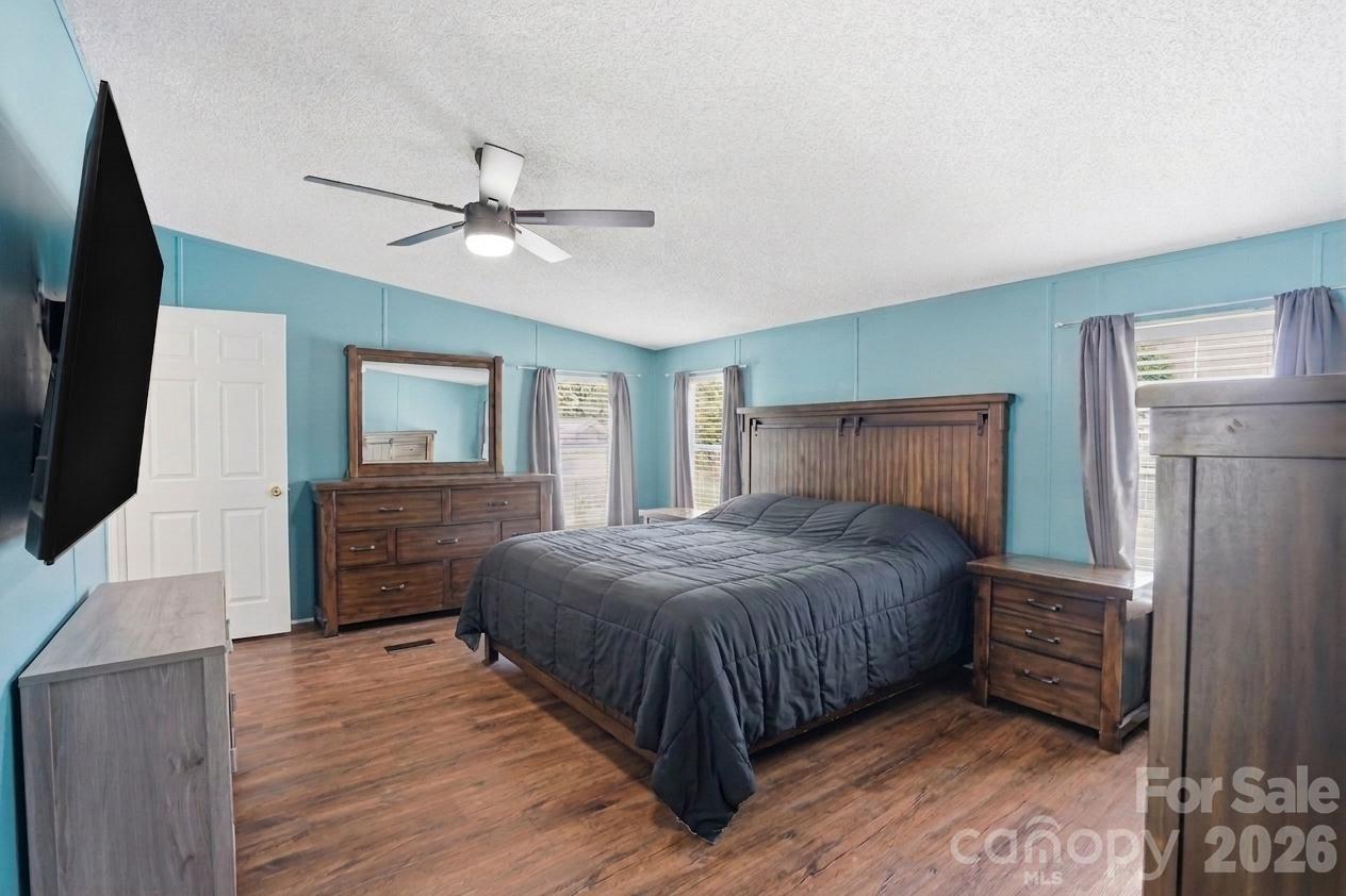 605 Ridgewood Court Mount Holly, NC 28120 - Photo 7 of 32 a bedroom with a bed dresser and a flat tv screen