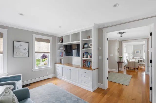 a living room with furniture and a book shelf