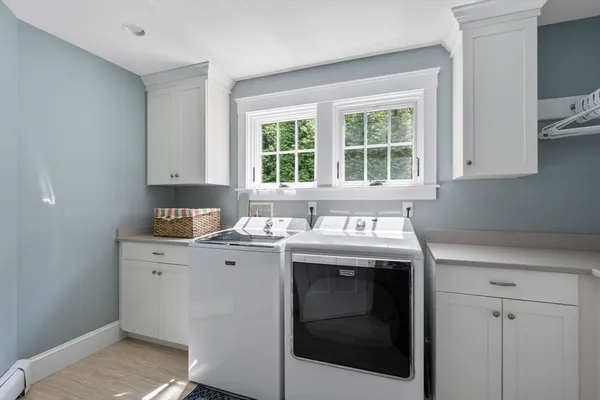 a view of cabinets a sink and a stove in a kitchen