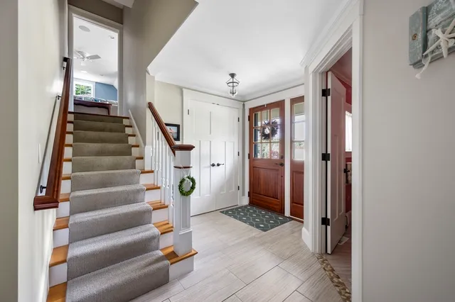 a view of entryway and hall with wooden floor