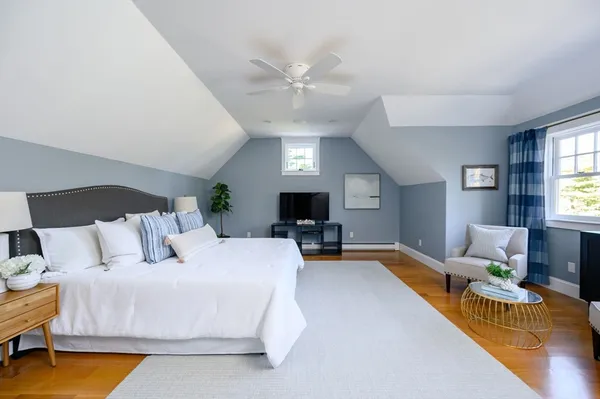 a living room with furniture fireplace and a large window