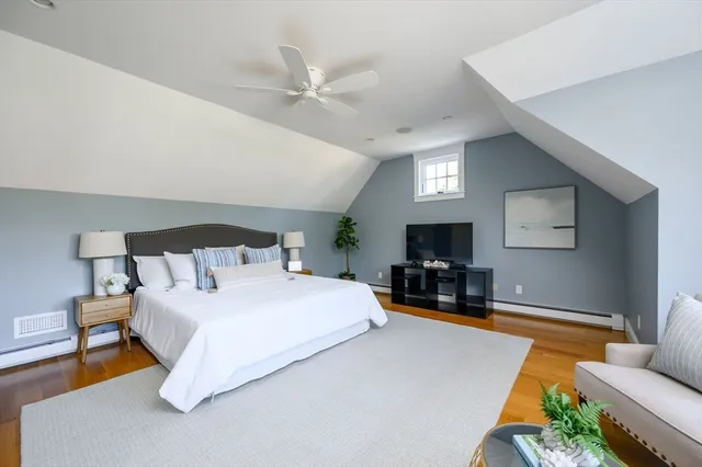a bedroom with furniture and a flat screen tv