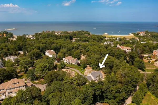 an aerial view of a houses with a lake view