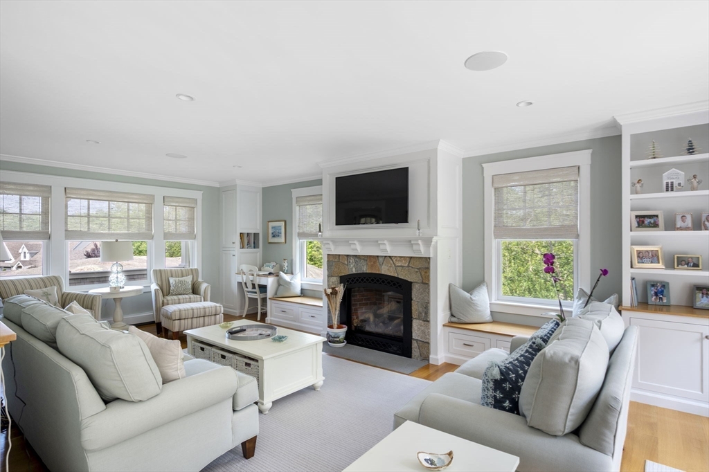 25 Mohawk Way Cohasset, MA 02025 - Photo 5 of 34 a living room with furniture a fireplace and a flat screen tv