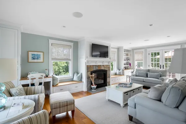 a living room with furniture flat screen tv and a fireplace