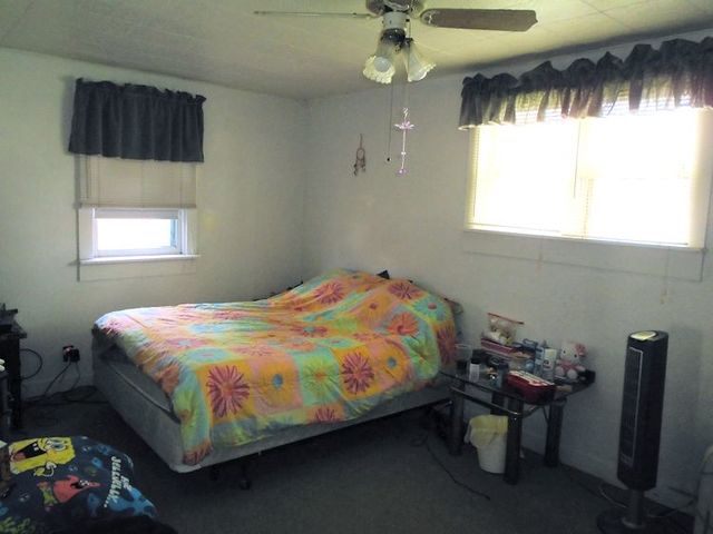 609 North 3rd Street Rochelle, IL 61068 - Photo 12 of 15 a bedroom with a bed a dresser and window