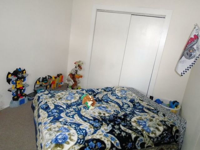 609 North 3rd Street Rochelle, IL 61068 - Photo 13 of 15 a bed sitting in a bedroom next to a window