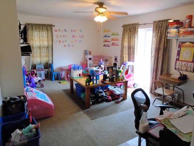 609 North 3rd Street Rochelle, IL 61068 - Photo 4 of 15 a play room with furniture and a chandelier