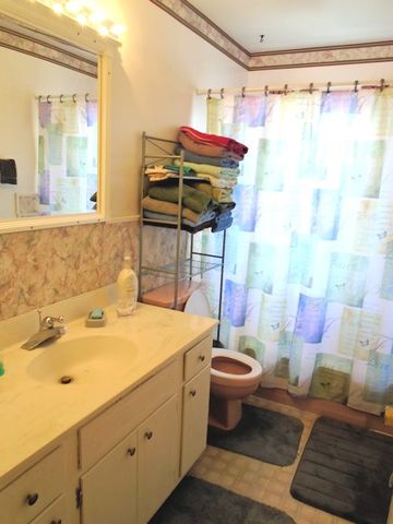609 North 3rd Street Rochelle, IL 61068 - Photo 8 of 15 a bathroom with a sink toilet and shower