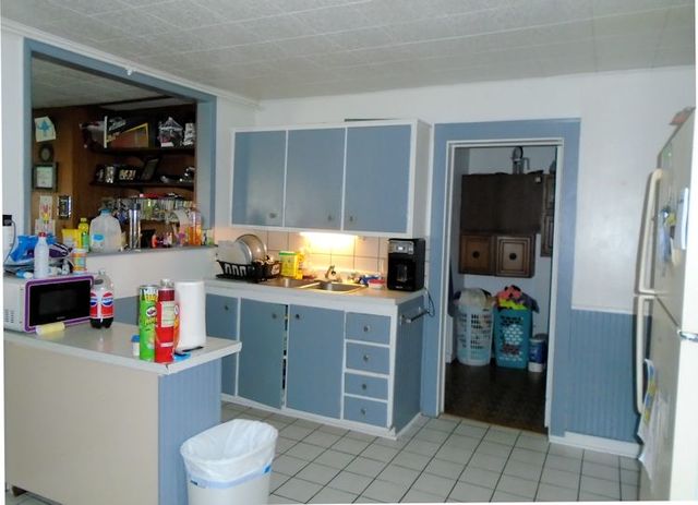 609 North 3rd Street Rochelle, IL 61068 - Photo 10 of 15 a kitchen with a refrigerator and cabinets