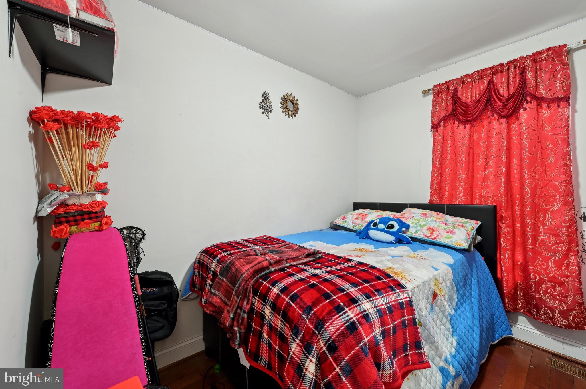 4101 Oak Road Baltimore, MD 21227 - Photo 12 of 25 a bedroom with a bed and flat screen tv