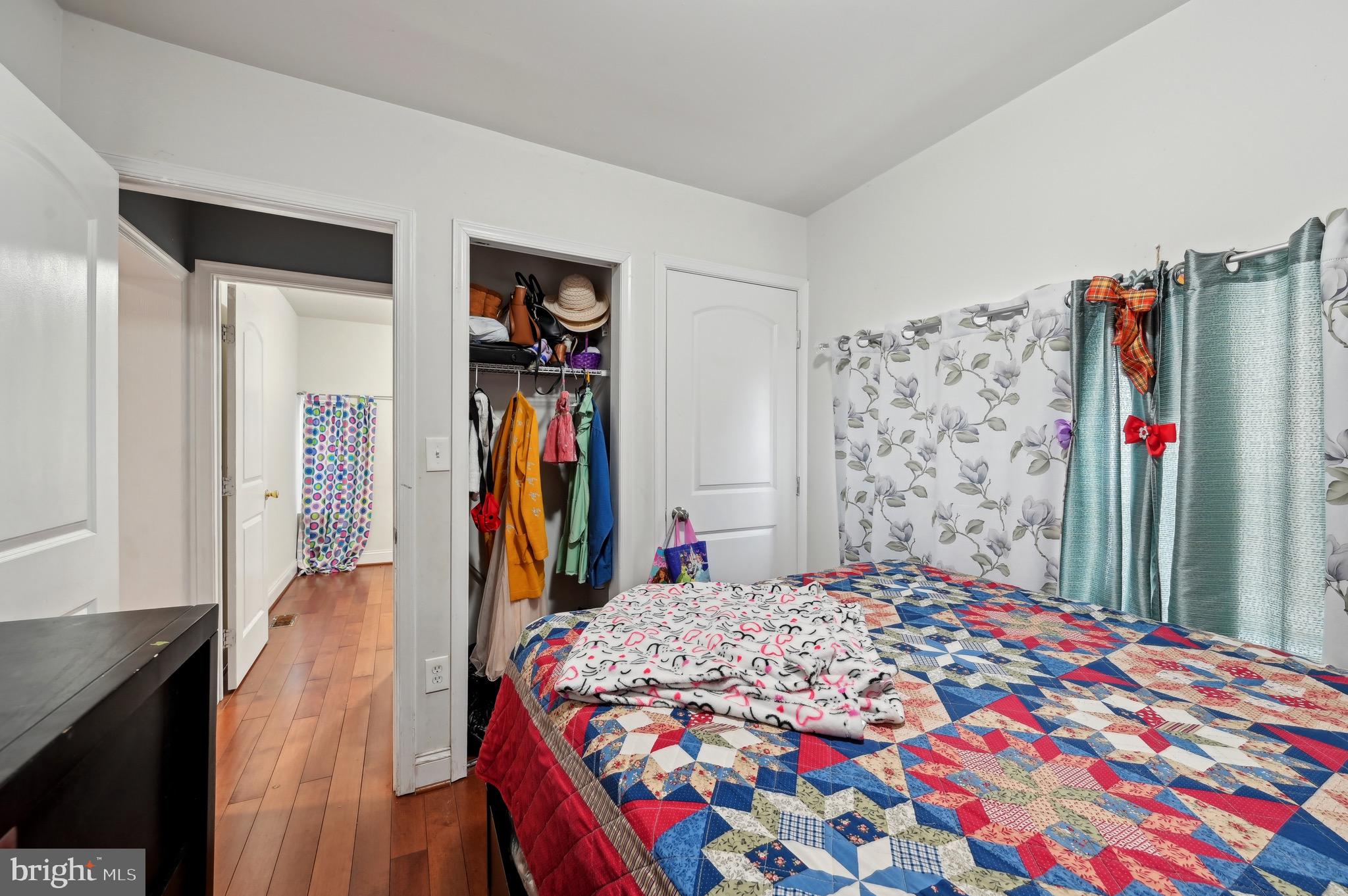4101 Oak Road Baltimore, MD 21227 - Photo 13 of 25 a bedroom with a bed a book shelf and a shower