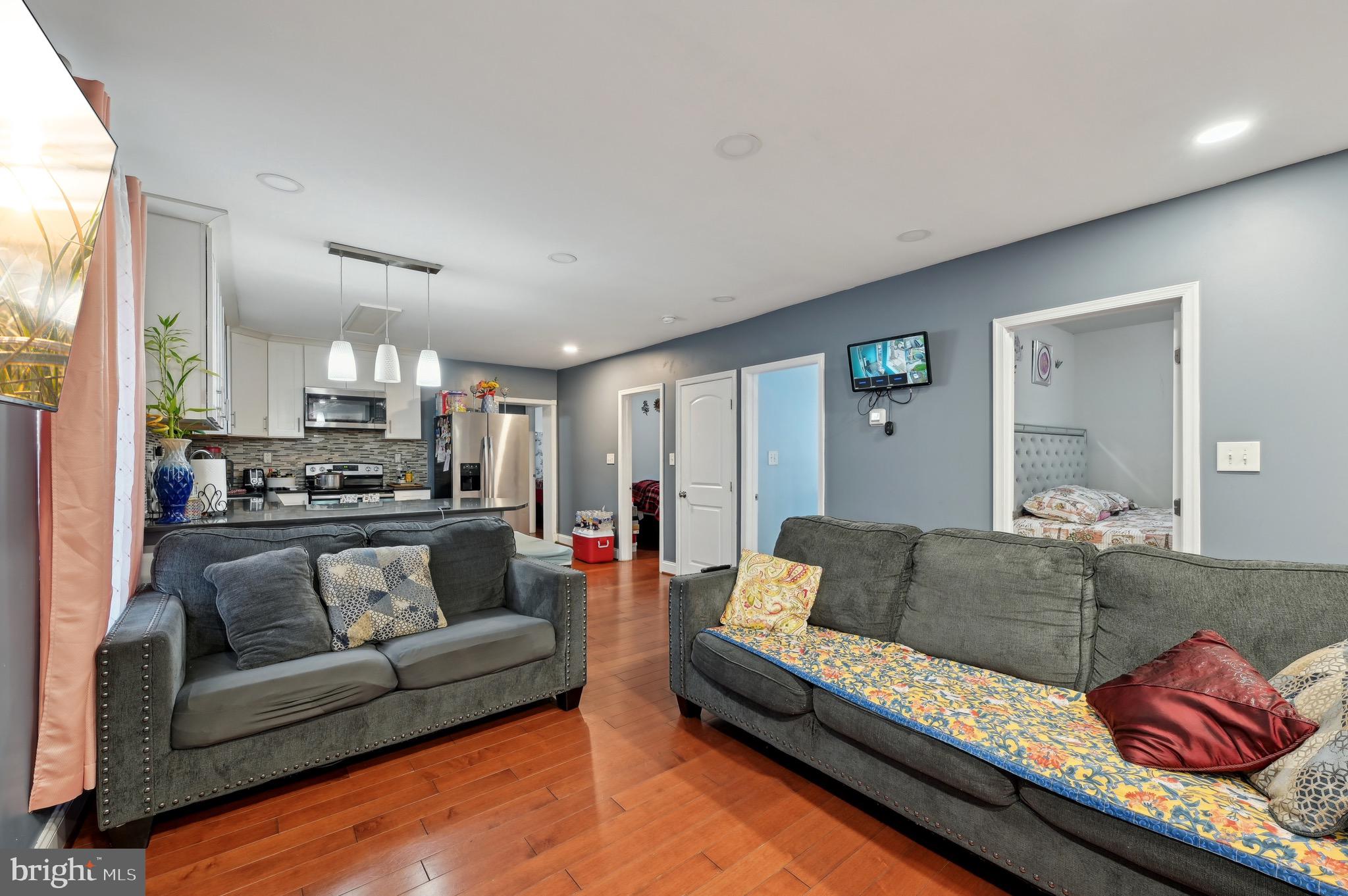 4101 Oak Road Baltimore, MD 21227 - Photo 5 of 25 a living room with furniture white walls and kitchen view