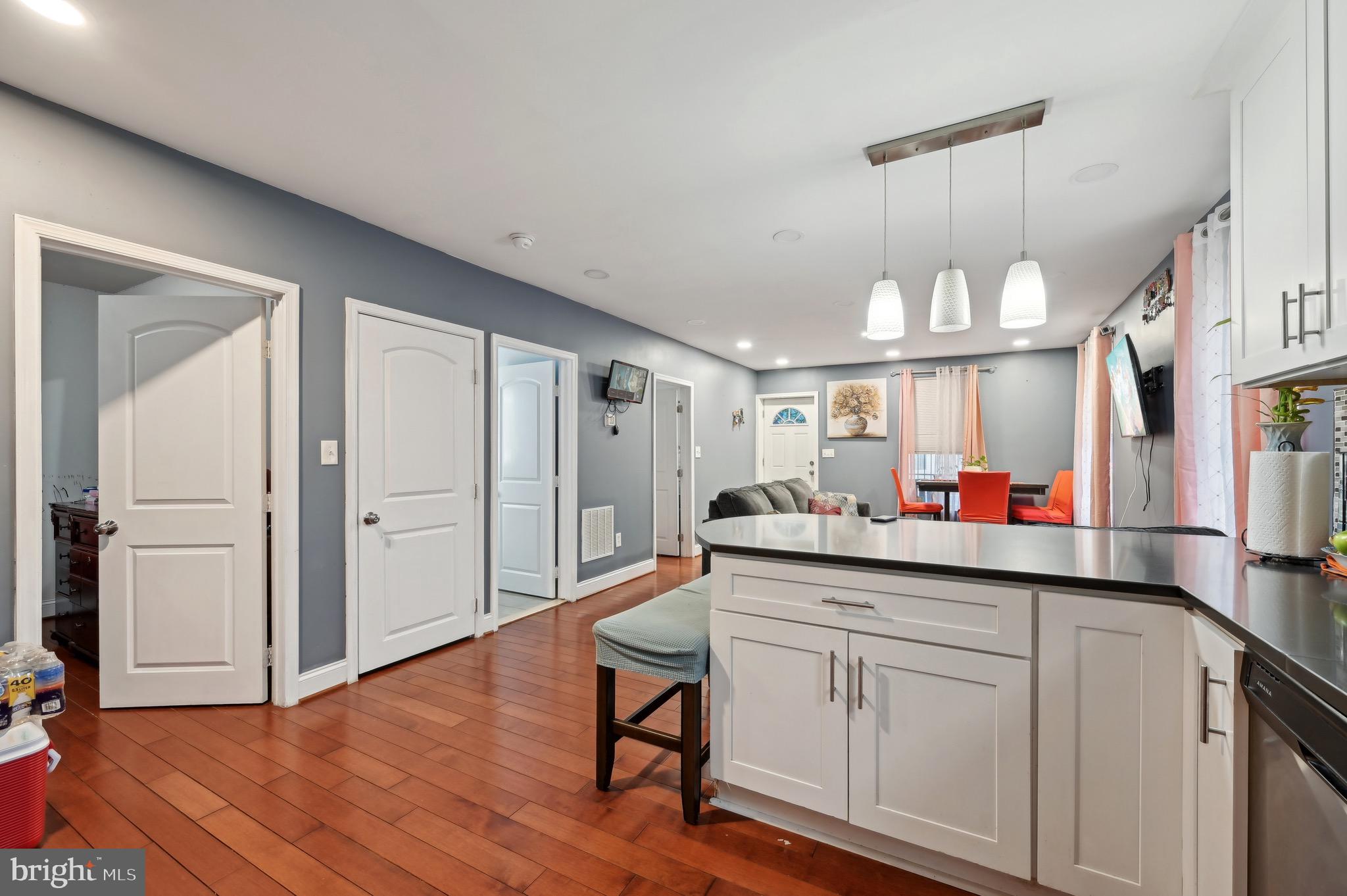 4101 Oak Road Baltimore, MD 21227 - Photo 9 of 25 a kitchen with white cabinets and wooden floor