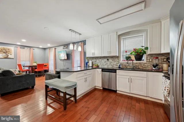 a kitchen with a refrigerator and a stove top oven