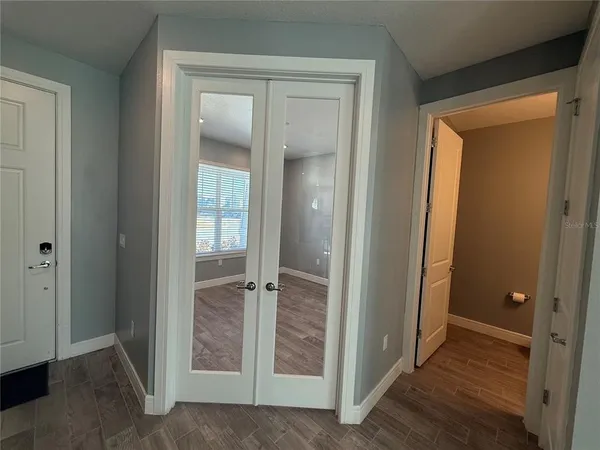 an empty room that has a wooden door