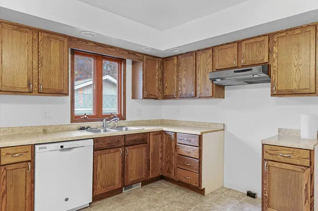a kitchen with a sink cabinets and window