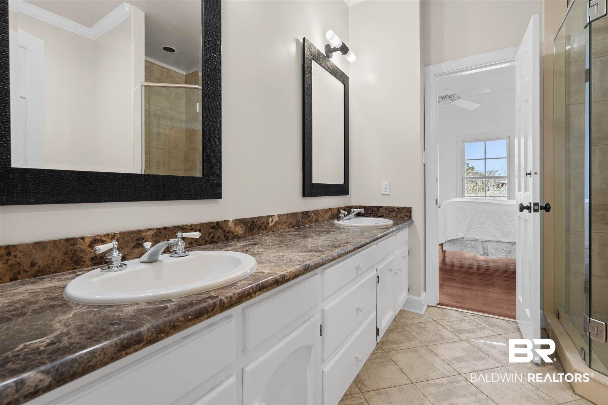 3615 Stein Street Mobile, AL 36608 - Photo 28 of 44 Bathroom featuring a shower stall, double vanity, crown molding, light tile patterned floors, and ensuite bath