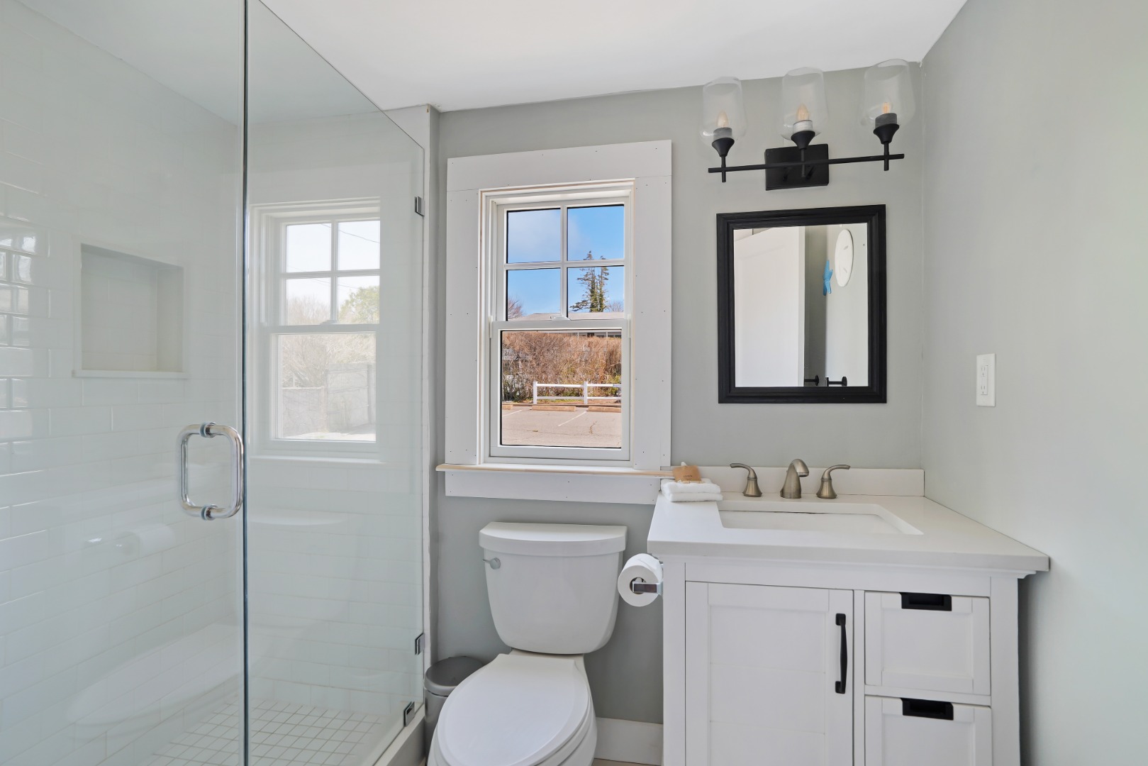 20 Peases Point Way North, Unit 4 Edgartown, MA 02539 - Photo 8 of 11 a bathroom with a toilet sink and mirror