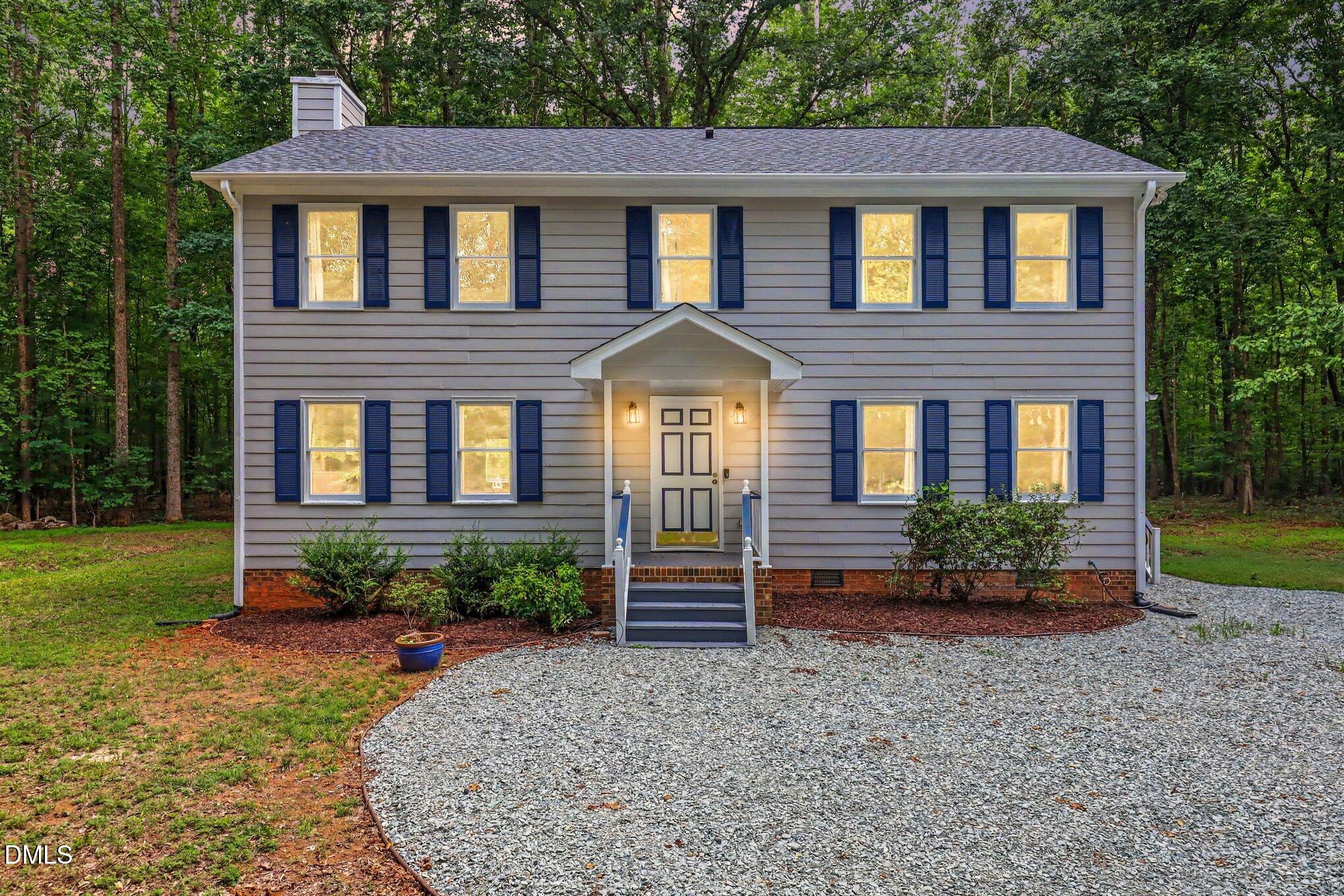 114 Oak Hollow Road Timberlake, NC 27583 - Photo 1 of 31 Two-story residential exterior featuring light gray siding and dark blue shutters