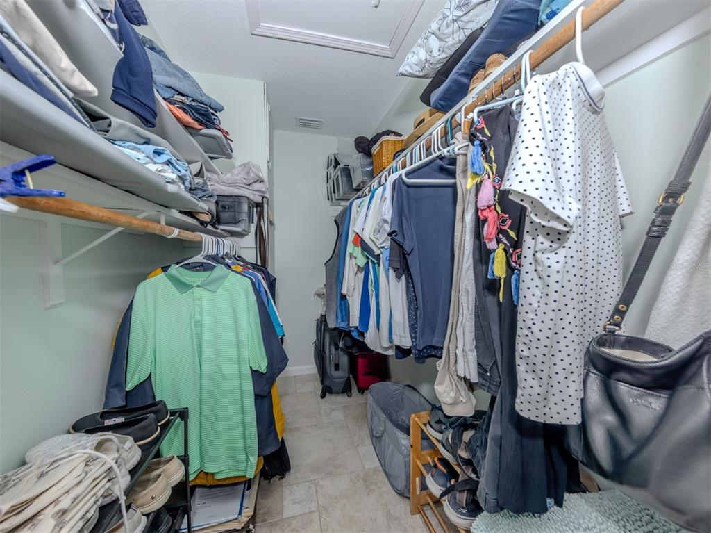 1977 Beach Road, Unit 83 Englewood, FL 34223 - Photo 21 of 48 a view of walk in closet with clothes and shoes