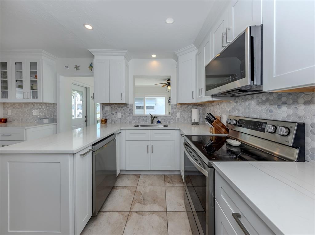 1977 Beach Road, Unit 83 Englewood, FL 34223 - Photo 4 of 48 a kitchen with a sink stove and microwave