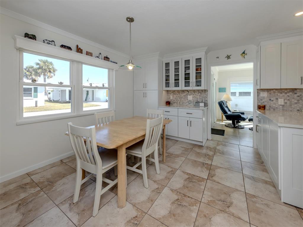 1977 Beach Road, Unit 83 Englewood, FL 34223 - Photo 7 of 48 a view of a dining room with furniture and windows