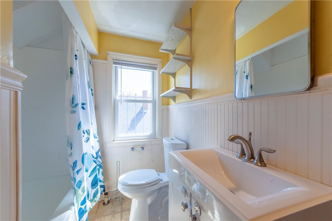 27 Eaton Street Pawtucket, RI 02861 - Photo 17 of 27 Bath has tub and shower with vinyl floor