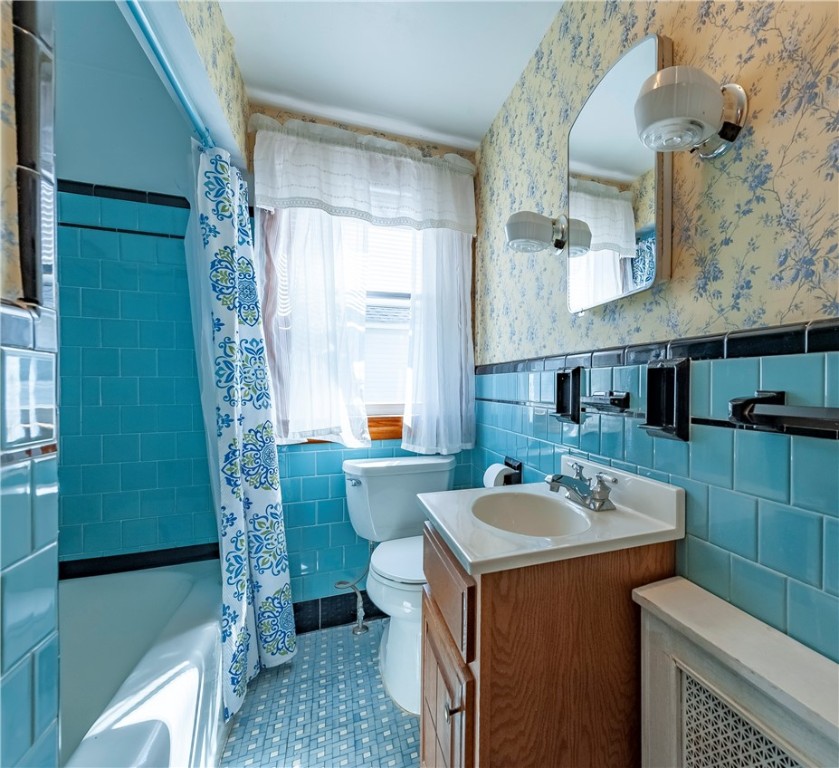 27 Eaton Street Pawtucket, RI 02861 - Photo 8 of 27 First floor bath has ceramic walls and floor with tub and shower.