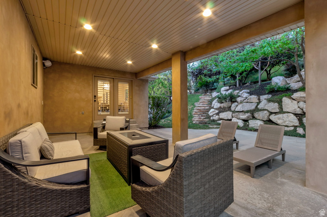 577 South Ridge Top Lane East North Salt Lake, UT 84054 - Photo 48 of 57 Covered outdoor living area with recessed lighting, generous entertaining space, and a seamless connection to the beautifully landscaped backyard.