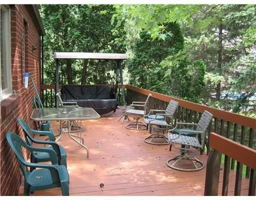 a view of balcony with wooden floor and outdoor seating