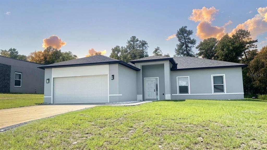 13751 Southwest 43rd Circle Ocala, FL 34473 - Photo 1 of 1 a front view of a house with yard and garage