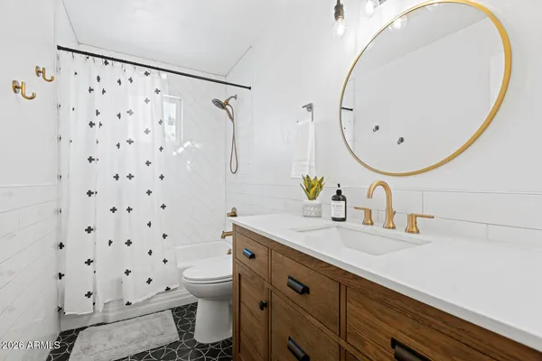 a bedroom with a bed and painting on the wall